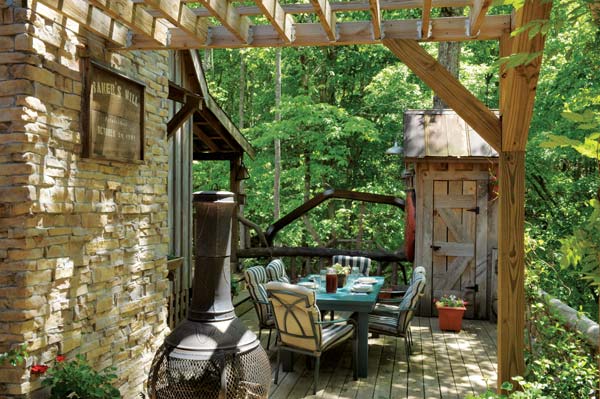 The Bakers cleared a minimal amount of forest trees for their small cabin. The surrounding trees provide an elegant backdrop for the outdoor kitchen.